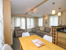 A living room with furniture and a dining area at Dove in Shobdon