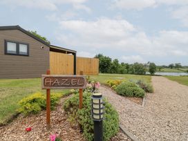 An outdoor area with a sign and flower beds at Hazel in Oakthorpe near Donisthorpe