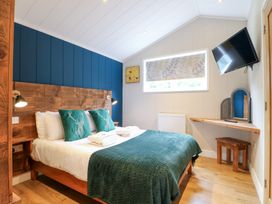 A bedroom with a bed and television at Hazel in Oakthorpe near Donisthorpe