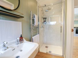 A bathroom with a shower and bathtub at Hazel in Oakthorpe near Donisthorpe