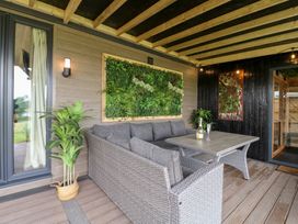 An outdoor seating area with a sofa and table at Hazel in Oakthorpe near Donisthorpe