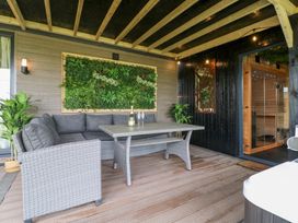 An outdoor living area with seating and sauna at Hazel in Oakthorpe near Donisthorpe