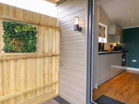 A kitchen viewed from the outside with a fence and plant at Hazel in Oakthorpe near Donisthorpe