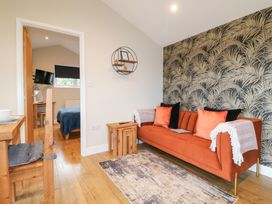 A living room with a sofa and side table at Birch in Oakthorpe near Donisthorpe