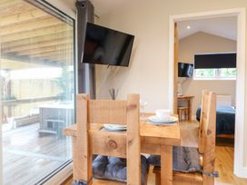 A dining area with a wooden table and chairs at Birch in Oakthorpe near Donisthorpe
