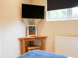 A bedroom with a television on a table at Birch in Oakthorpe near Donisthorpe