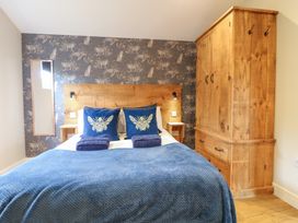 A bedroom with a bed and wardrobe at Birch in Oakthorpe near Donisthorpe