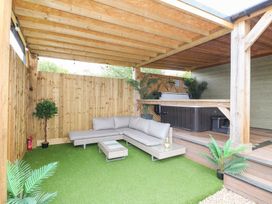 An outdoor seating area with a sofa and a hot tub at Birch in Oakthorpe near Donisthorpe