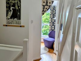 A hallway with wall art and a purple chair at Harbour Retreat in Weymouth