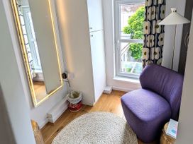 A room with a purple chair and a mirror at Harbour Retreat in Weymouth