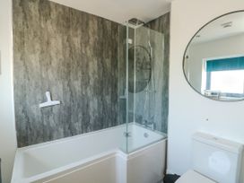 A bathroom featuring a bathtub and shower at Iscoed in Rhosneigr