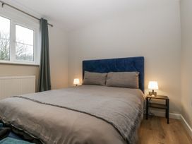 A bedroom with a bed and a bedside table at Ranbir House Longhope