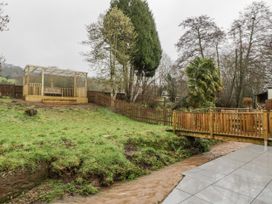 A garden with a wooden gazebo and a stream at Ranbir House Longhope