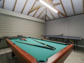 A game room with a pool table and ping pong table at Ranbir House in Longhope