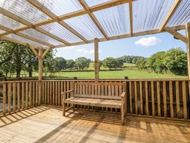 An outdoor patio with a wooden bench at Ranbir House in Longhope
