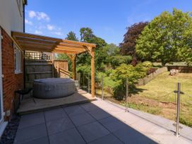 An outdoor space with a hot tub and decking at Ranbir House in Longhope