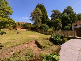 A garden with a wooden deck and a stream at Ranbir House in Longhope