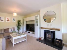 A living room with a sofa and television at Tansea in Hope Cove