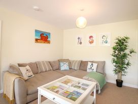 A living room with a sofa and coffee table at Tansea in Hope Cove