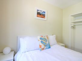 A bedroom with a bed and a closet at Tansea in Hope Cove