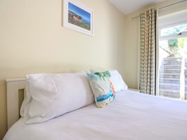 A bedroom with a bed and a window at Tansea in Hope Cove