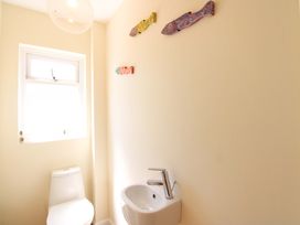 A bathroom with a toilet and sink at Tansea in Hope Cove