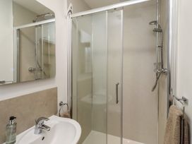 A bathroom with a shower and sink at Brucap Cottage Beadnell