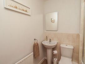 A bathroom with a sink and toilet at Brucap Cottage Beadnell