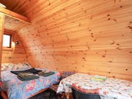 A bedroom with a bed and a table at Pod 1