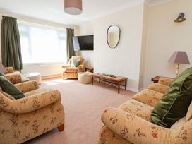 A living room with sofas and a coffee table at Bryn Bach in Rhos-On-Sea