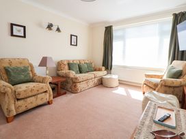 A living room with seating and a window at Bryn Bach in Rhos-On-Sea