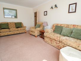A living room with two sofas and an armchair at Bryn Bach in Rhos-On-Sea
