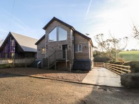 A modern house with a wooden exterior and a driveway at The Hideaway in 