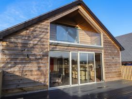 A house with a wooden exterior and balcony at The Hideaway in 