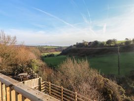 An outdoor view of a field with trees and a power line at The Hideaway in 