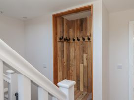 An entryway with coat hooks and wood paneling at The Hideaway