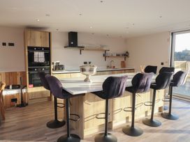 A kitchen with an island and bar stools at The Hideaway