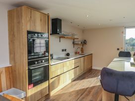 A kitchen with cabinets and countertop at The Hideaway in 