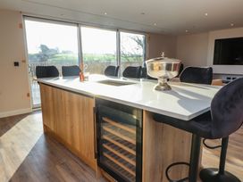 A kitchen with an island and bar stools at The Hideaway