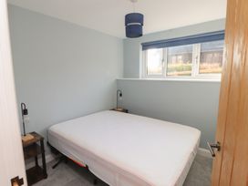 A bedroom with a bed and nightstand at The Hideaway in 