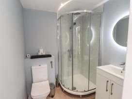 A bathroom with a shower cubicle and a sink at The Hideaway