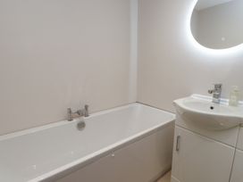 A bathroom with a bathtub and a sink at The Hideaway