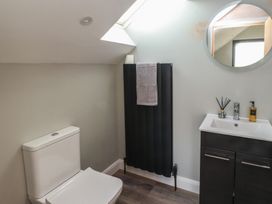 A bathroom with a toilet, sink, and towel rack at The Hideaway