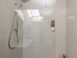 A shower area with a shower head and control panel at The Hideaway