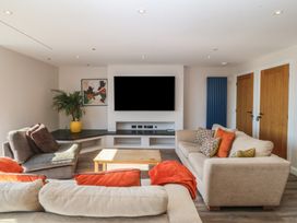 A living room with a sofa and television at The Hideaway in Mynytho near Abersoch
