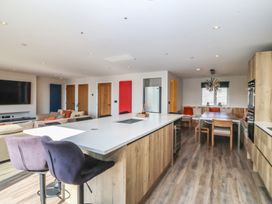 A kitchen with an island and dining area at The Hideaway Mynytho near Abersoch