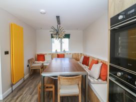 A dining room with a table and chairs at The Hideaway in Mynytho near Abersoch