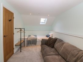 A bedroom with a bed and a sofa at The Hideaway Mynytho near Abersoch