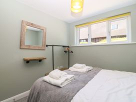 A bedroom with towels on a bed at The Hideaway Mynytho near Abersoch
