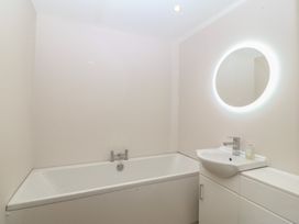 A bathroom with a bathtub and sink at The Hideaway in Mynytho near Abersoch